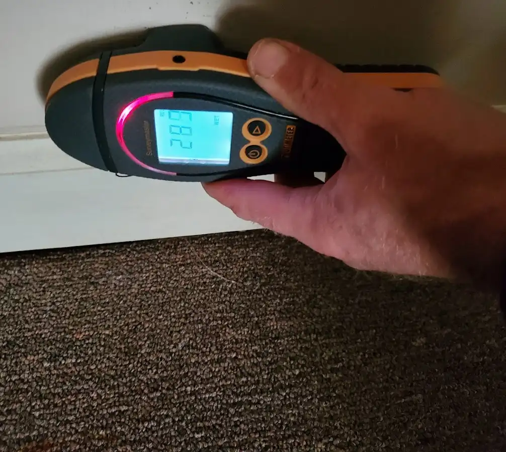 Moisture detection at baseboard during Storm Damage Restoration in McAllen
